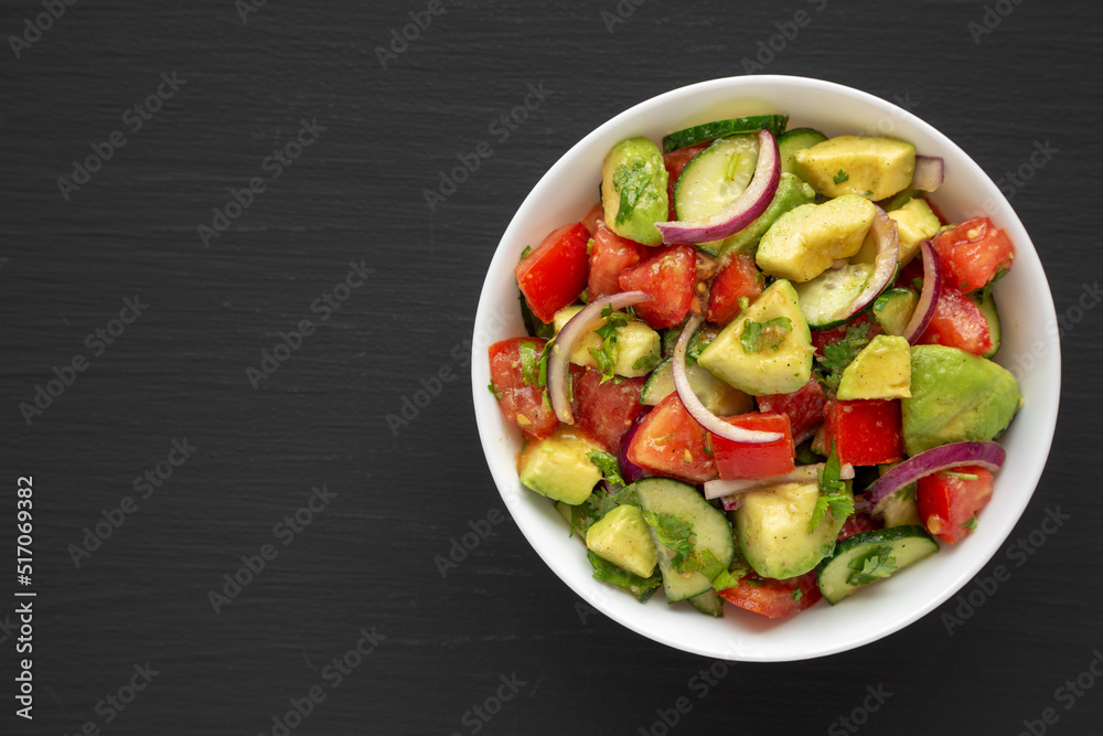 Homemade Organic Cucumber, Tomato and Avocado Salad in a Bowl, top view. Flat lay, overhead, from above. Space for text.