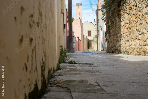 Small alley of Archanes, in Crete, with traditional houses. View from below.
