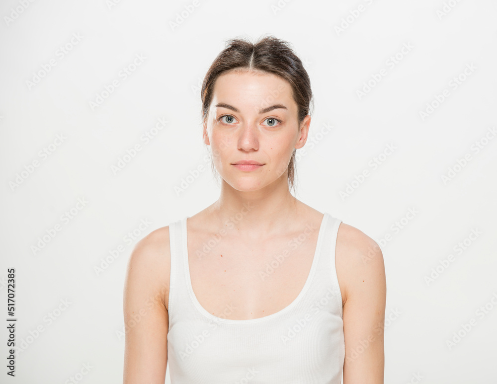 Close-up portrait of a beautiful young woman dressed in a white t-shirt isolated on white.'portrait of a young Ukrainian girl with different emotions Close-up portrait of a beautiful young woman dressed in a white t-shirt isolated on white.'portrait of a young Ukrainian girl with different emotions