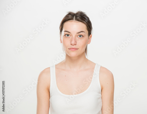 Close-up portrait of a beautiful young woman dressed in a white t-shirt isolated on white.'portrait of a young Ukrainian girl with different emotions