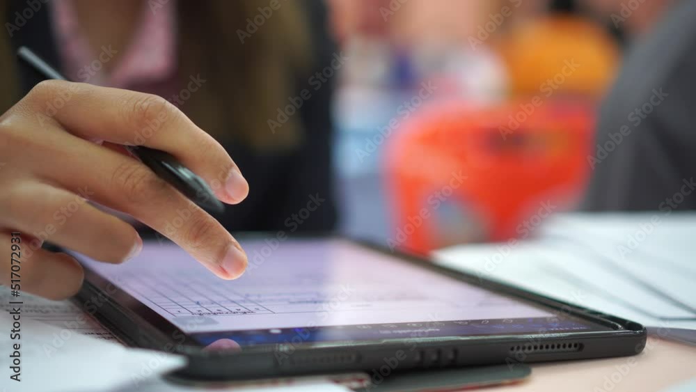 Loei, Thailand-May 9, 2022: Asian Woman Teacher using Finger touching gadget choose app on smartphone mobile phone. Browsing apps icon while open e-learning online tablet at meeting room. Loei, Thailand-May 9, 2022: Asian Woman Teacher using Finger touching gadget choose app on smartphone mobile phone. Browsing apps icon while open e-learning online tablet at meeting room.