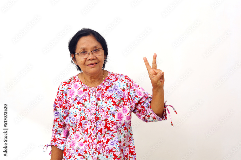 Happy asian elderly woman standing and showing two finger. Isolated on white background Happy asian elderly woman standing and showing two finger. Isolated on white background