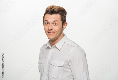 close-up portrait of a man in a white shirt on a white background isolated.portrait of a man with different emotions isolated. © serhii