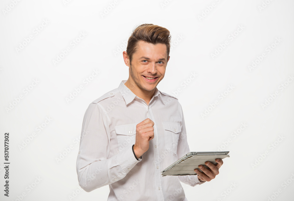 a man in a white shirt uses a tablet on a white isolated background.close-up portrait of a man with a tablet emotionally a man in a white shirt uses a tablet on a white isolated background.close-up portrait of a man with a tablet emotionally