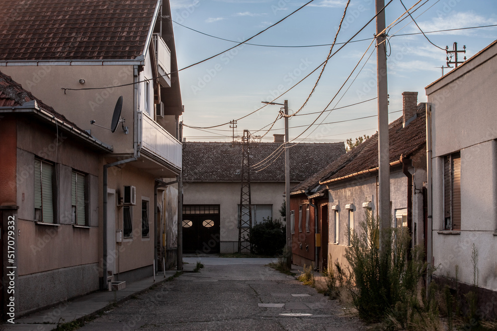 Selective blur on a typical Serbian village street zwith housing buidings, individual houses, in the city of Sremska Mitrovica, one of the main cities of Northern Serbia, in Vojvodina province...
