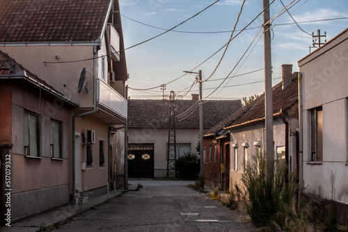 Selective blur on a typical Serbian village street zwith housing buidings, individual houses, in the city of Sremska Mitrovica, one of the main cities of Northern Serbia, in Vojvodina province... © Jerome