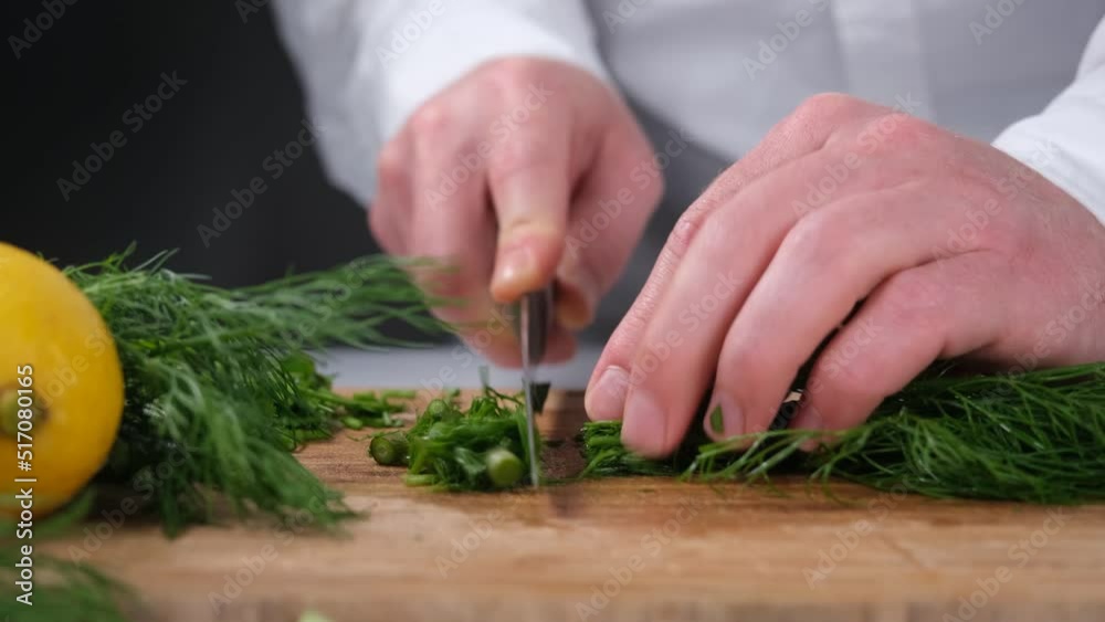chef cutting dill