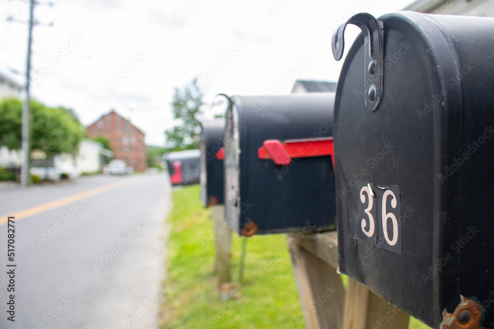 line of street-side residential mailboxes in perspective line of street-side residential mailboxes in perspective