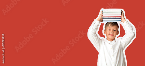 Little schoolboy holding ma...