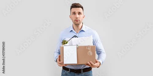 Dismissed man holding box w...