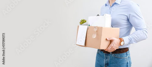 Dismissed man with personal things on light background with space for text