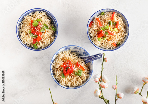 Bowl of tasty noodles on light background