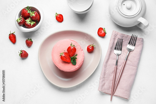 Composition with pink pancakes and strawberry on light background