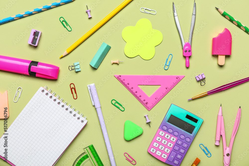 Different school stationery on green background, top view Different school stationery on green background, top view