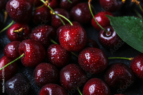 Tasty ripe cherry with water drops as background, closeup