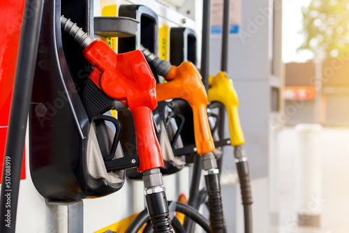 Refuel the car.Fuel nozzle. Higher oil prices.Refueling the car at a gas station fuel pump. Man driver hand refilling and pumping gasoline oil the car with fuel at he refuel station. 