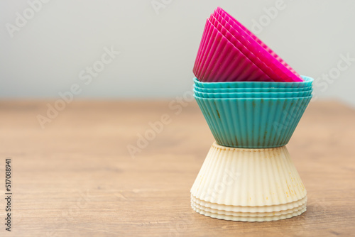 colored cupcake molds with copy space in purple  blue and white