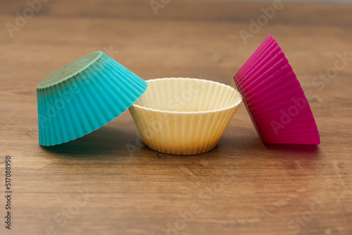 group of colored silicone molds for cupcake  in white  purple and blue colors