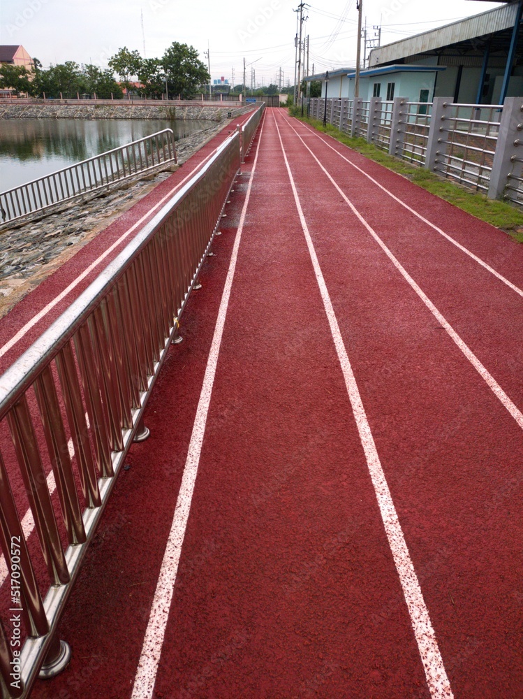 running track in a stadium,Red running track in the park after the rain stops