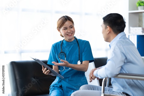 Doctor and patient sitting and talking at medical examination at hospital office, close-up. Therapist filling up medication history records. Medicine and healthcare concept.