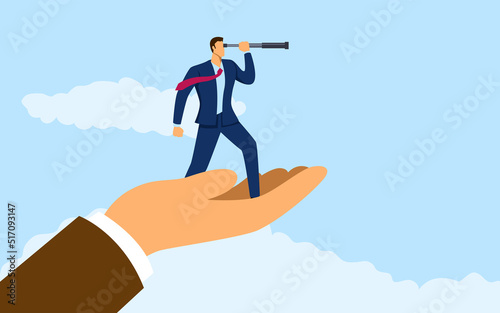 Hand holding a businessman using telescope
