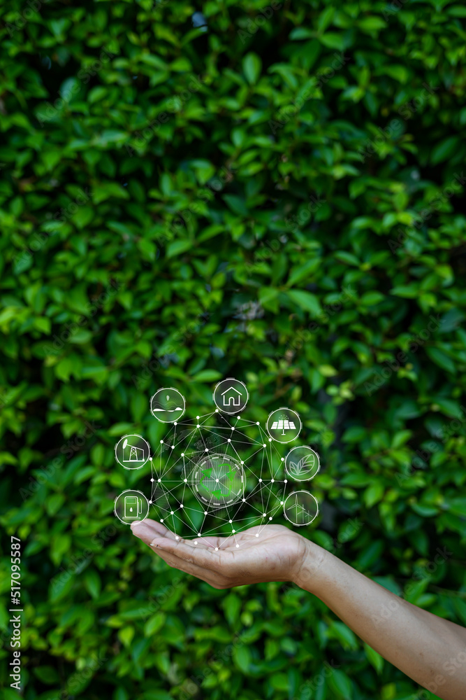 Technology, hand holding with environment Icons over the Network connection on green background