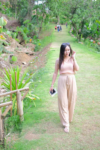 Beautiful young woman walking down from mountain
