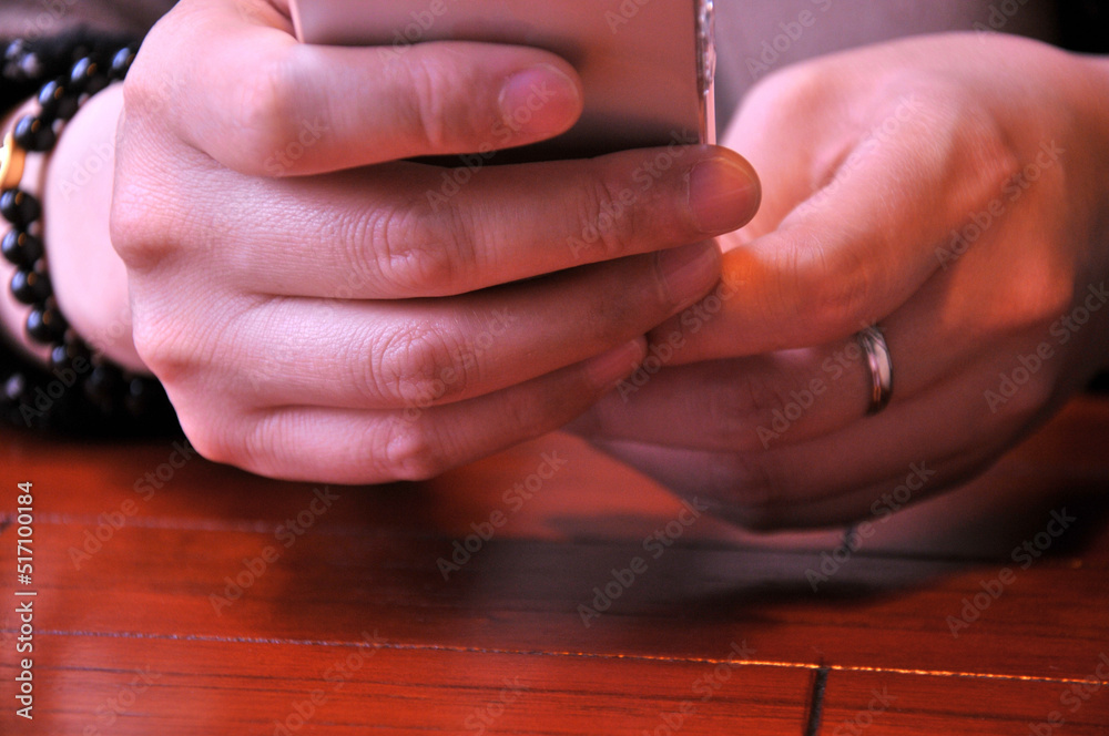 Obraz premium Holding and touching on mobile phone with silver screen