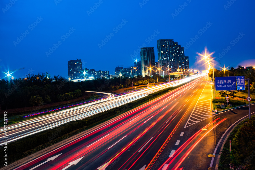 Long-exposure shot of a highway illuminated with colorful lights