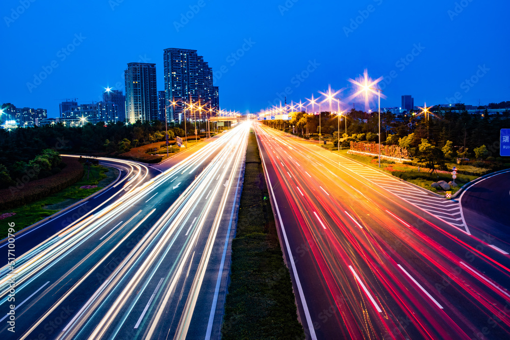 Long-exposure shot of a highway illuminated with colorful lights