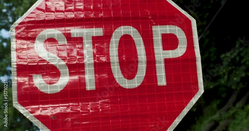 Road Construction Flagger Turning Sign from Slow to Stop While Directing Traffic