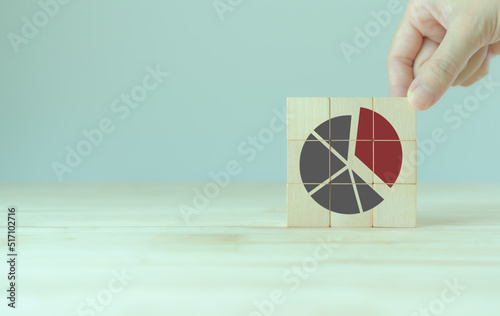 Increase market share, growth of business profit concept. Market penetration and expansion strategies. Wooden cubes showing a market share percentage using a pie chart. Strengthen business strategies.