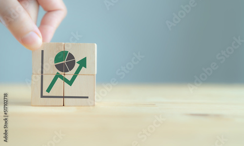 Increase market share, growth of business profit. Market penetration and expansion strategies. Wooden cubes showing a market share percentage using a pie chart. Growing green business market concept. photo