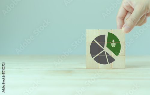 Growing green business market concept. Increase market share, growth of business profit. Market penetration and expansion strategies. Wooden cubes showing a market share percentage using a pie chart.