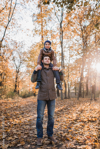 boy with dad in autumn forest with orange leaves © dyachenkopro