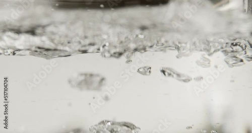 Boiling water in a pot super close up shot, 4k, super slow motion, 240 fps, macro shot