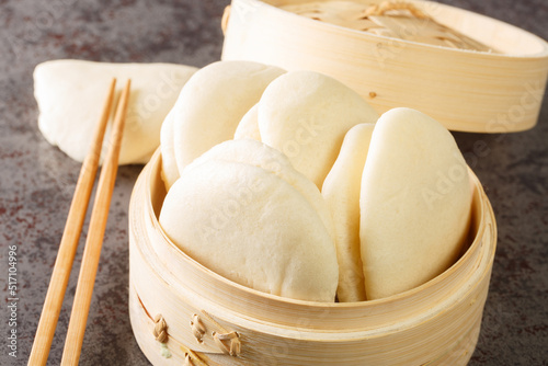 Gua bao, Bao bread in bamboo steamer closeup on the table. Horizontal photo