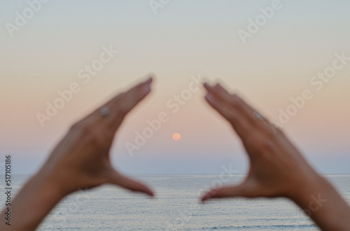 Full Moon moonrise between hands Sunshine Beach Noosa Heads Australia supermoon  photo
