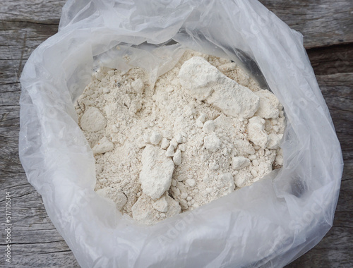 Lime in plastic bags is used as fertilizer to nourish trees planted in agricultural gardens.