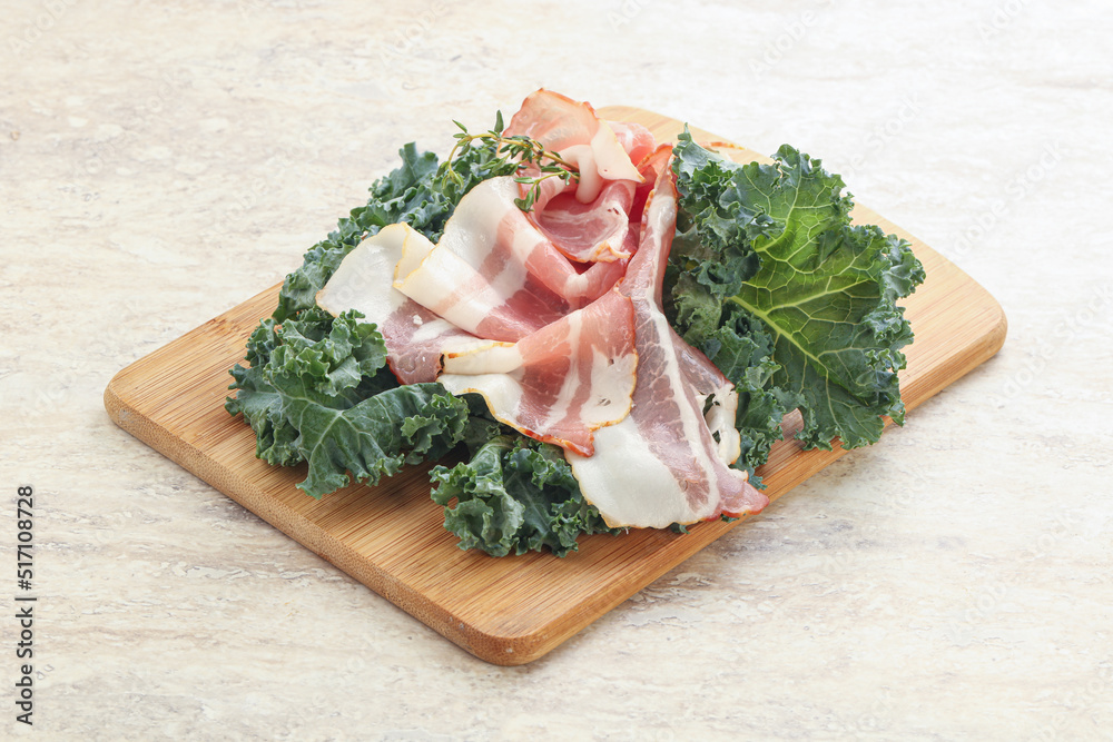 Raw pork bacon over board