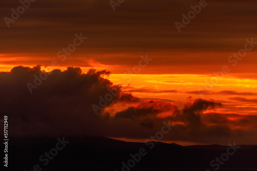 Bright dawn in the sea. Beautiful scarlet and red clouds during a colorful sunrise in Vladivostok.