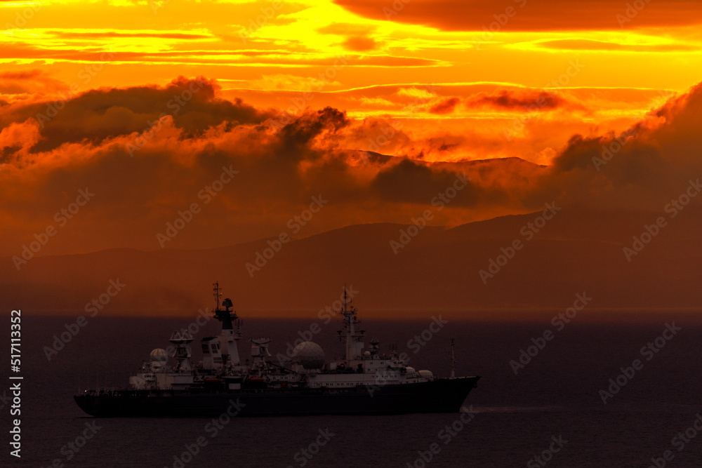 Bright dawn in the sea. Beautiful scarlet and red clouds during a colorful sunrise in Vladivostok.