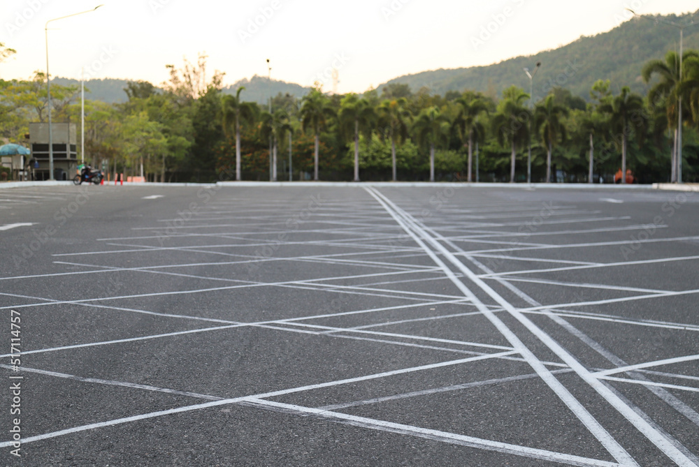 Image of empty  parking lot with natural background. in twilight evening. 