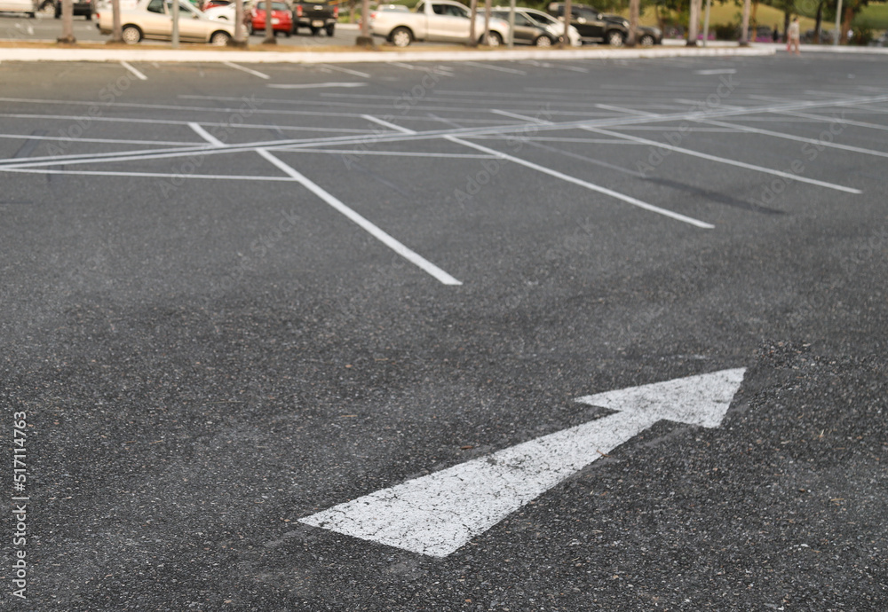Closeup of arrow sign on asphalt ground of the parking lot. Closeup of arrow sign on asphalt ground of the parking lot.