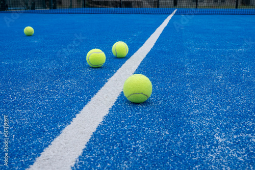 Bright blue tennis, paddle ball or pickleball court close up of service line outdoors. selective focus © Vic