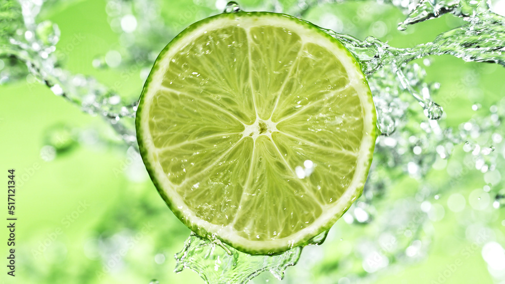 Slice of lime with water splashes on green background. Slice of lime with water splashes on green background.