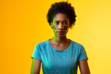 Image of african american female soccer fan with flag of portugal in yellow lighting