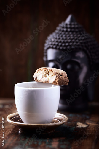 Cantuccini (Italian cookie) and a Cup of coffee on rustic wooden background. Close up. Copy space.