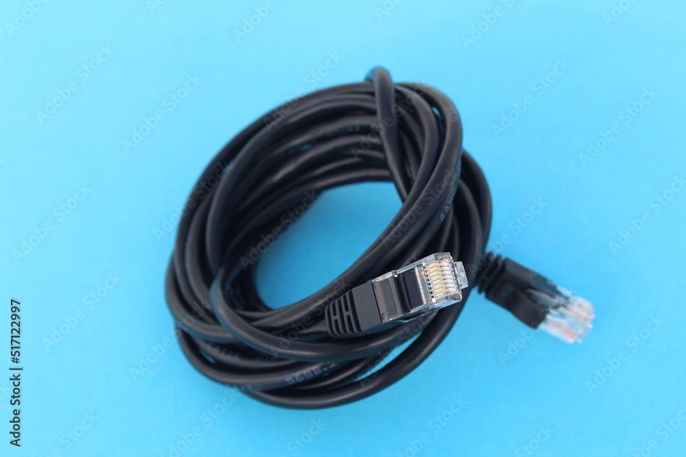 A wrapped cable lies on a blue background. A wrapped cable lies on a blue background.