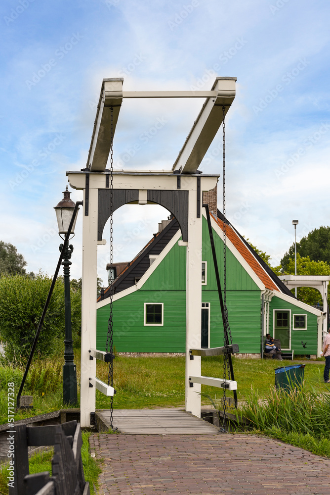 Koog aan de Zaan, Netherlands. July 2022. Traditional drawbridge and an authentic wooden facade on the Zaanse Schans.
